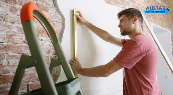 A man installing wallpaper